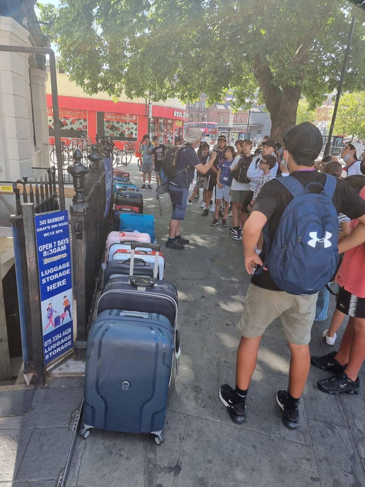 Person holding blue luggage